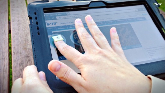 This person uses a fingernail-shaped chip to transfer data between a tablet and a smartpho...