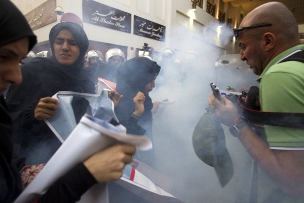  Nhiếp ảnh gia Reuters, ông Ahmed Jadallah cùng những người biểu tình đang phản ứng lại sau khi cảnh sát sử dụng lựu đạn âm thanh rong một cuộc biểu tình chống chính phủ, yêu cầu thả nhà hoạt động Abdulhadi al-Khawaja ở Manama, Bahrain vào ngày 18/4/2012.