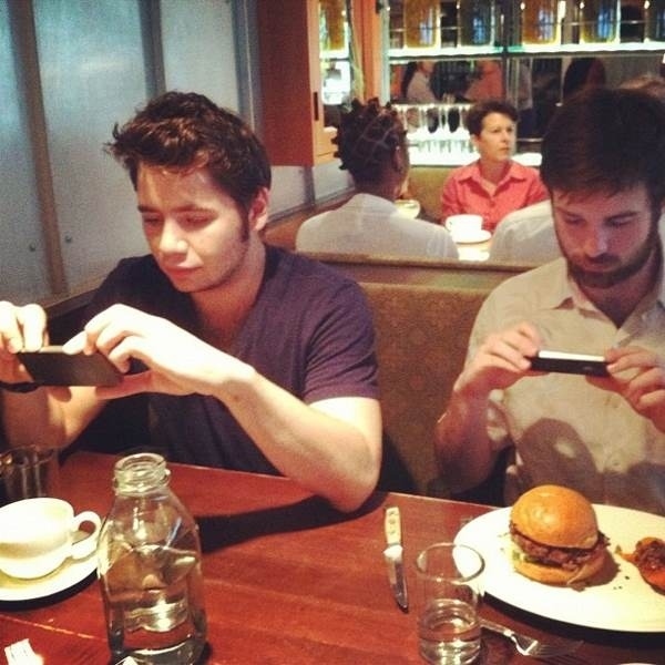 This picture of best friends enjoying a delicious burger and a coffee: