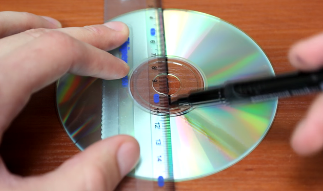  Đầu tiên bạn hãy dùng bút dạ quang và thước kẻ lần lượt vẽ 4 đường thẳng lên đĩa CD. 