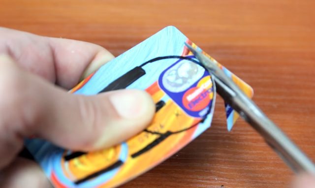  Bây giờ bạn hãy dùng 1 chiếc thẻ ATM đã bỏ, vẽ 1 vòng tròn trong đó và dùng kéo để cắt lấy nó ra. 