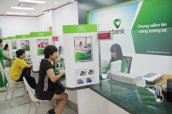  Khách hàng đang thực hiện giao dịch tại quầy giao dịch của ngân hàng. Ảnh minh họa: Vietcombank 