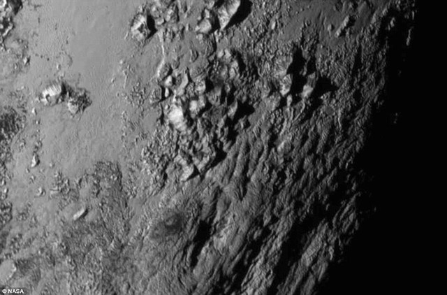 The first ever high-resolution image of Pluto has been beamed back to Earth showing water ice and 11,000ft (3,350 metre) mountains. The mountains likely formed no more than 100 million years ago - mere youngsters relative to the 4.56-billion-year age of the solar system. Nasa says they may still be in the process of building