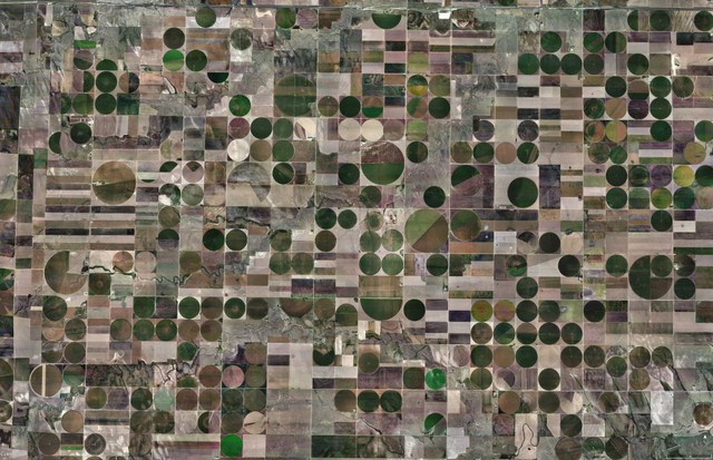 Center-pivot irrigation, a way of watering crops with sprinklers, dot the square fields in West Kansas, USA. Today, the majority of them are propelled by electric motors.