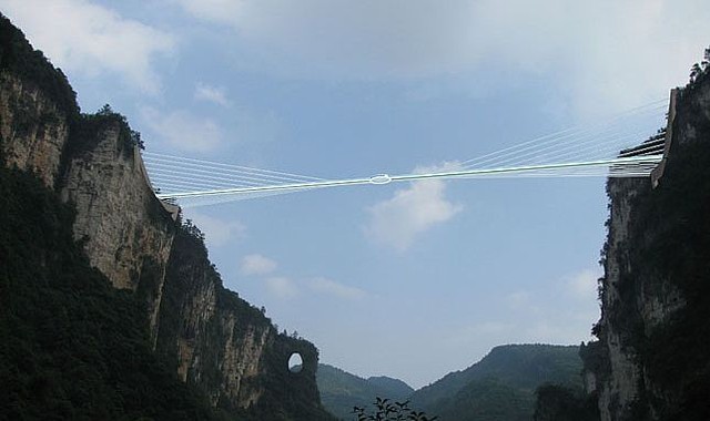 The glass bridge spans 370 m (1,214 ft) across the Zhangjiajie Grand Canyon
