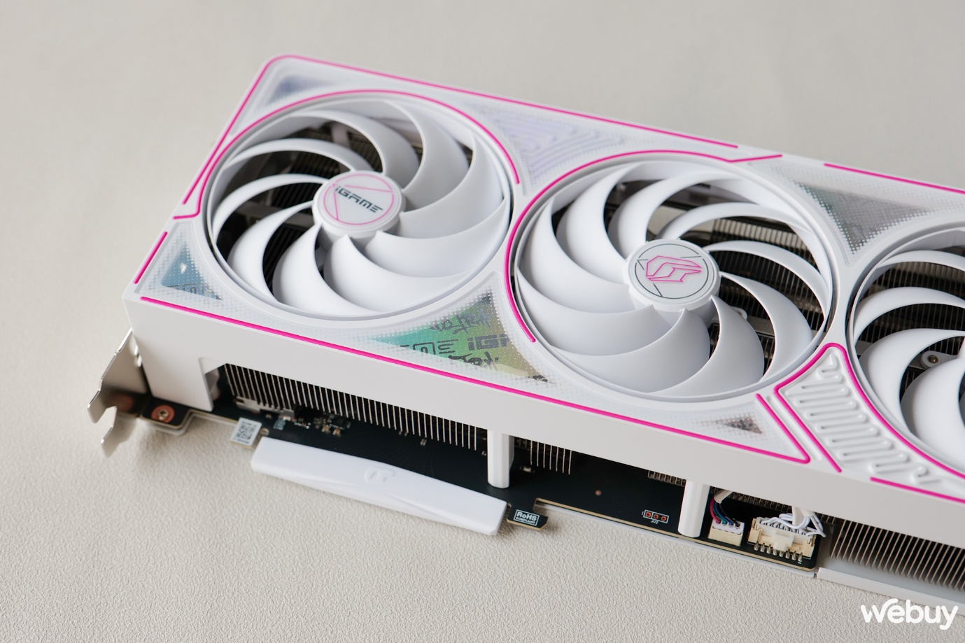 A white fan with pink trim Description automatically generated