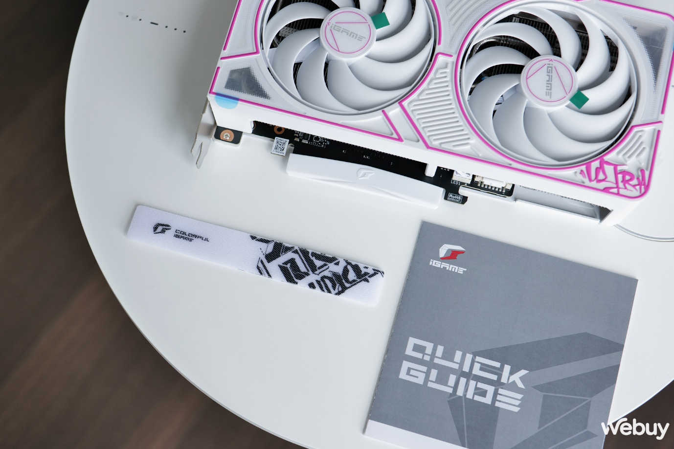 Mở hộp Colorful iGame GeForce RTX 5060 Ti Ultra W DUO OC 16GB-V: Giữ nguyên phong cách hip-hop giống bản 5080 với mức giá nhẹ nhàng hơn- Ảnh 3. A fan and a manual on a table AI-generated content may be incorrect.