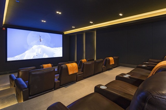 Downstairs is an indoor movie theater with deluxe seating.