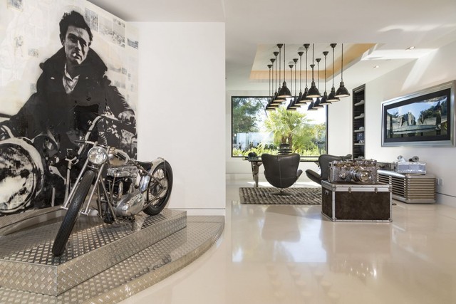 An open office is off to the side, with a motorcycle on display.