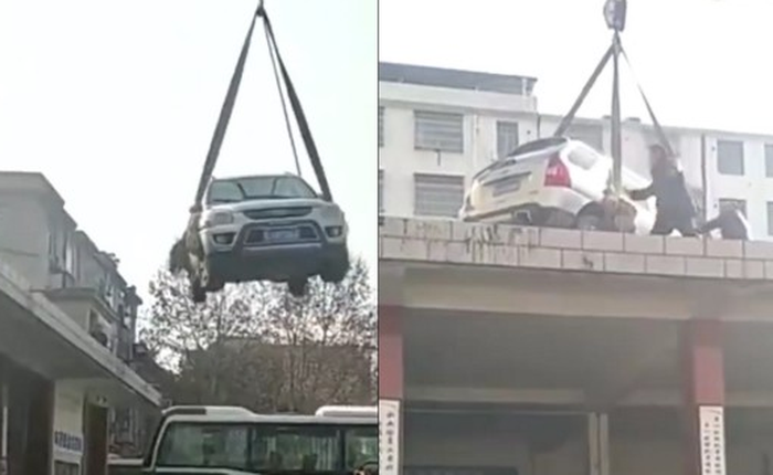 Trung Quốc: Chiếc SUV bị cẩu lên nóc nhà vì đỗ ngang trái giữa bến xe bus