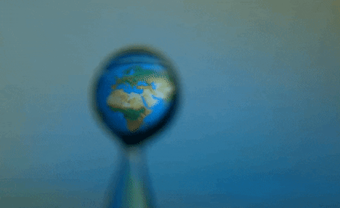 Xem bản đồ thế giới được đưa vào một giọt nước trong video chuyển động siêu chậm